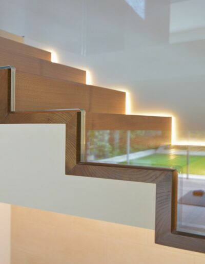 Close up of wooden floating staircase with a glass side