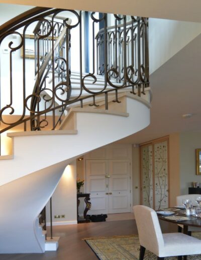 classic helical staircase leading to dinning area