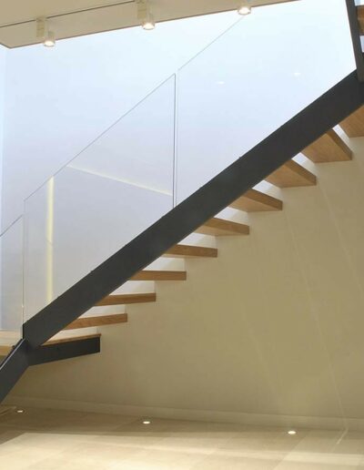 floating staircase with a pine and glass finish