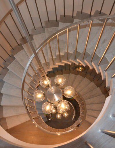 bespoke staircase with a helical style and modern light cluster in the centre